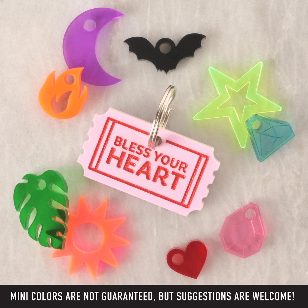 Bless Your Heart acrylic ticket pet charm with assorted mini charms including moon, bat, flame, star, leaf, sun, diamond, and heart.