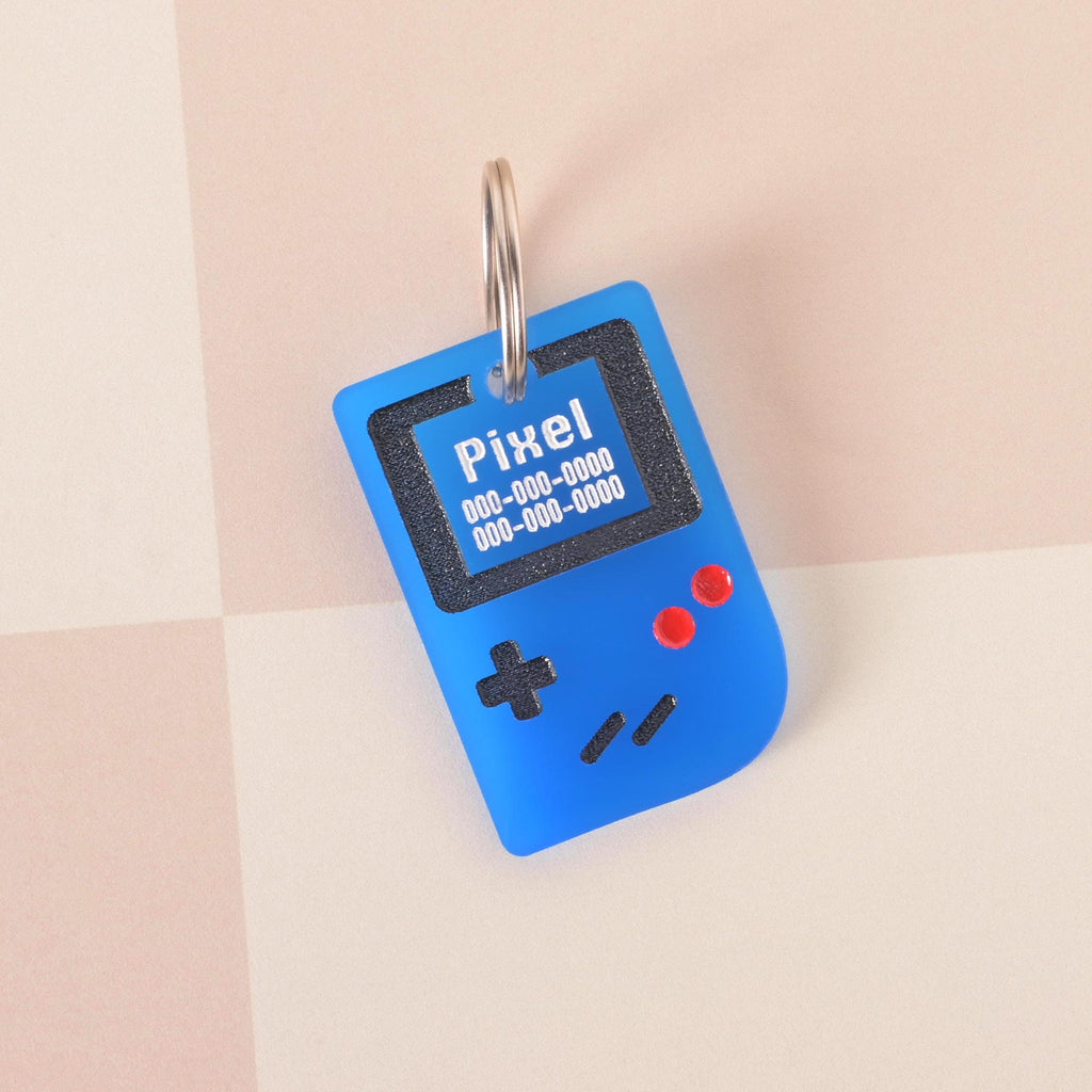 Blue retro game console pet ID tag with engraved name and phone number, fun geeky gamer pet tag for dogs and cats.