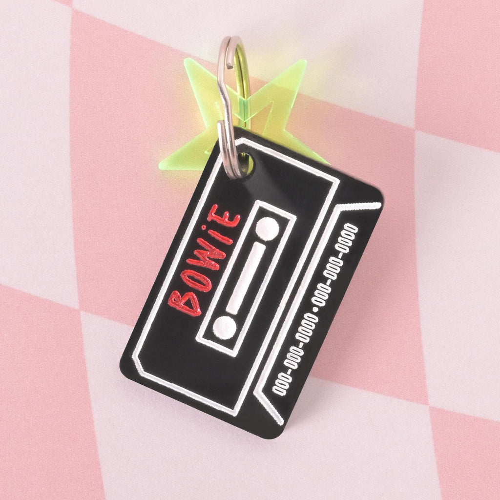 Retro black cassette tape pet ID tag with green star charm, customizable with pet name and phone number, fun design for dogs and cats.