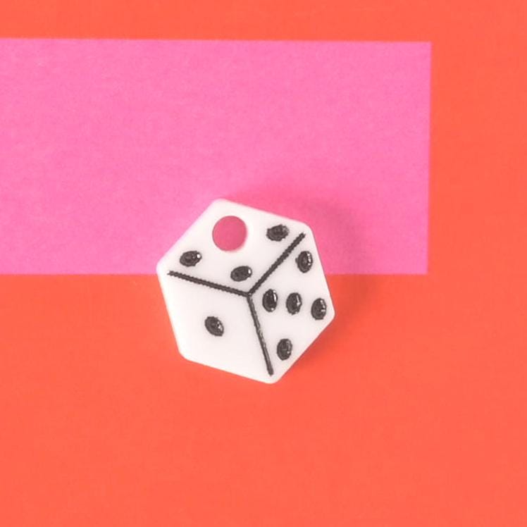 White acrylic dice-shaped pet charm with black dots, designed for pet collars and tags, a fun accessory for playful pets.