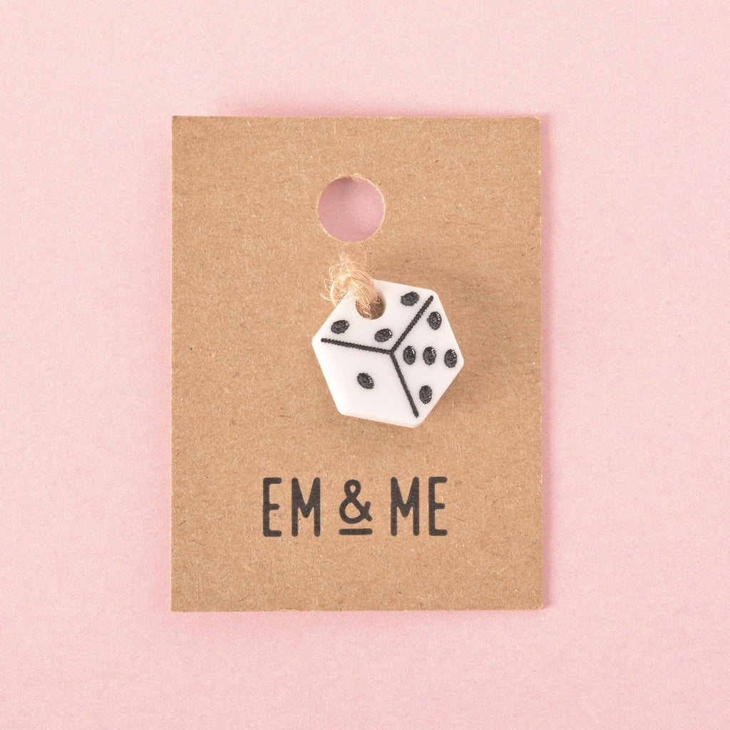 White acrylic dice pet charm with black dots displayed on an Em & Me branded backing card, a stylish accessory for pet collars and tags.
