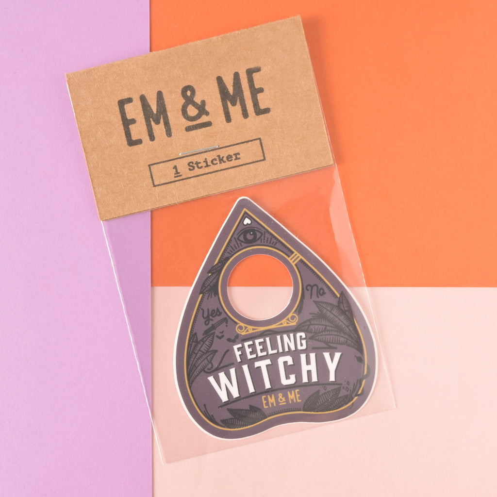 feeling witchy ouija planchet-shaped die cut sticker packaged in clear bag with kraft paper tag on color blocked background