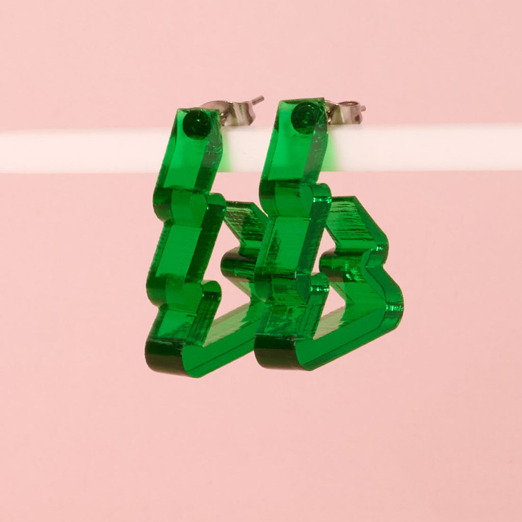 A pair of bold, translucent bright green acrylic earrings shaped like geometric lightning bolts or zig-zags. Lightweight and modern statement jewelry.