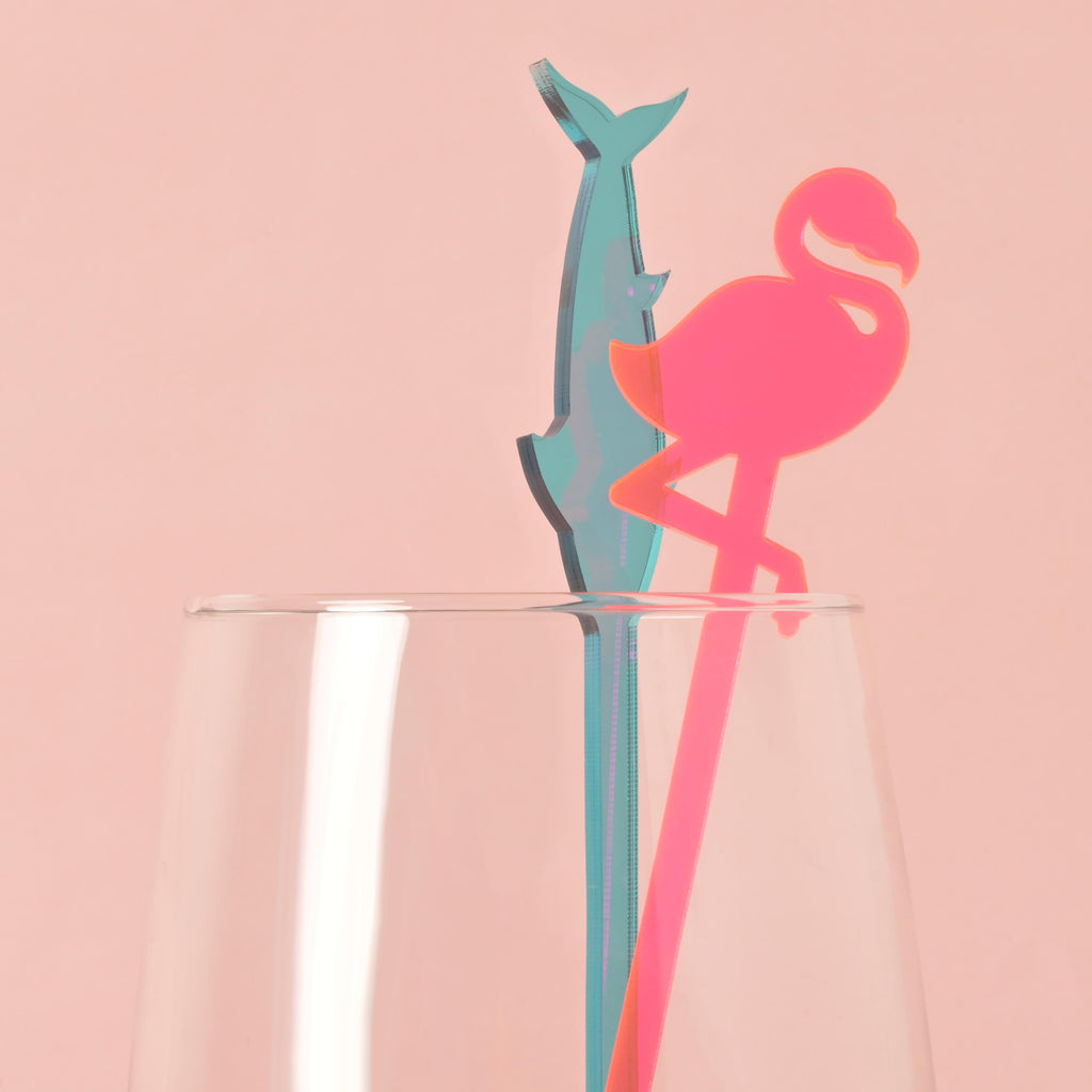 
Based on the image you've uploaded, here are the SEO values for the title and alt text.

SEO Title
Flamingo and Dolphin Cocktail Stirrers 🍹🦩

This title is concise and accurately describes the main subjects in the image. It uses relevant keywords like "flamingo," "dolphin," and "cocktail stirrers" to improve search visibility.

Alt Text
A pink flamingo and a blue dolphin-shaped cocktail stirrer are placed inside a clear glass. The background is a solid pink color.