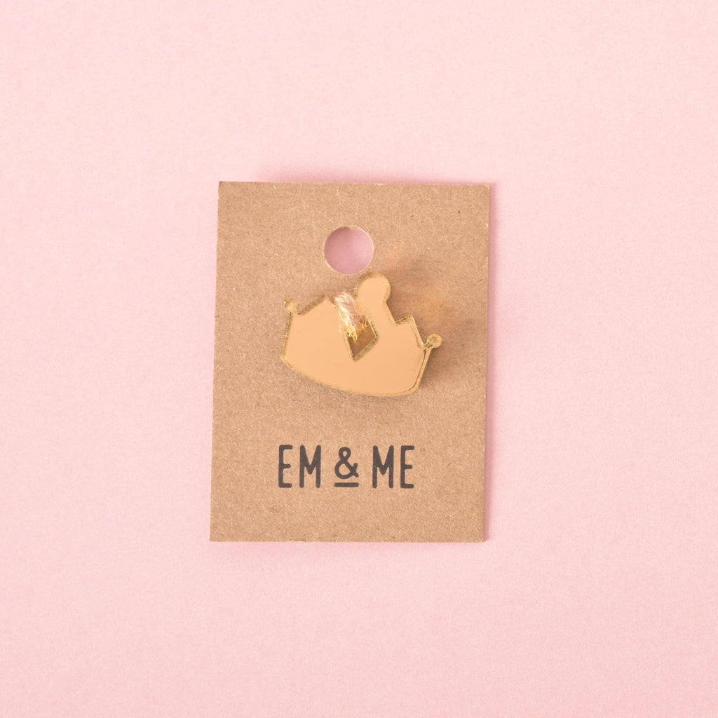 Gold acrylic crown-shaped pet charm with diamond cut-out detail, displayed on an Em & Me branded backing card for collars and tag accessories.