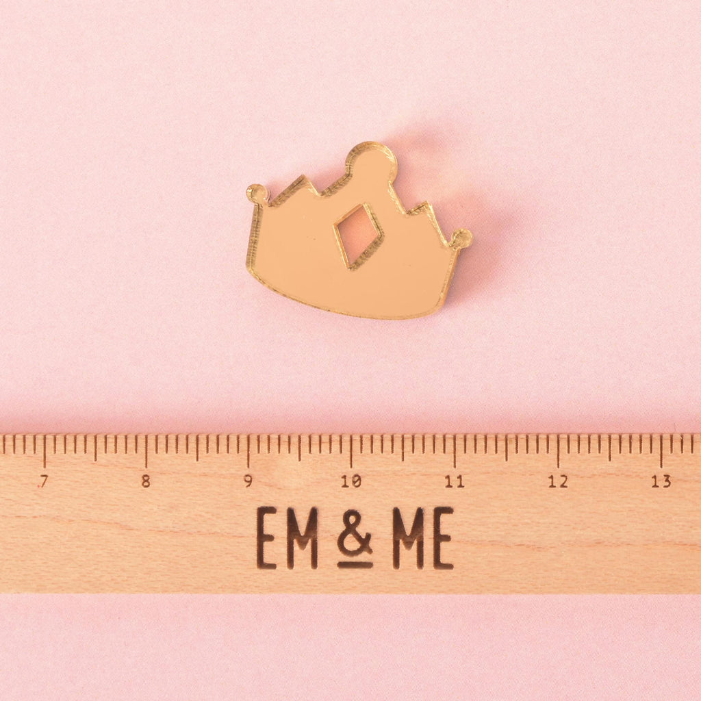 Gold acrylic crown pet charm with diamond cut-out detail shown above a ruler for size reference, a stylish accessory for pet collars and tags.