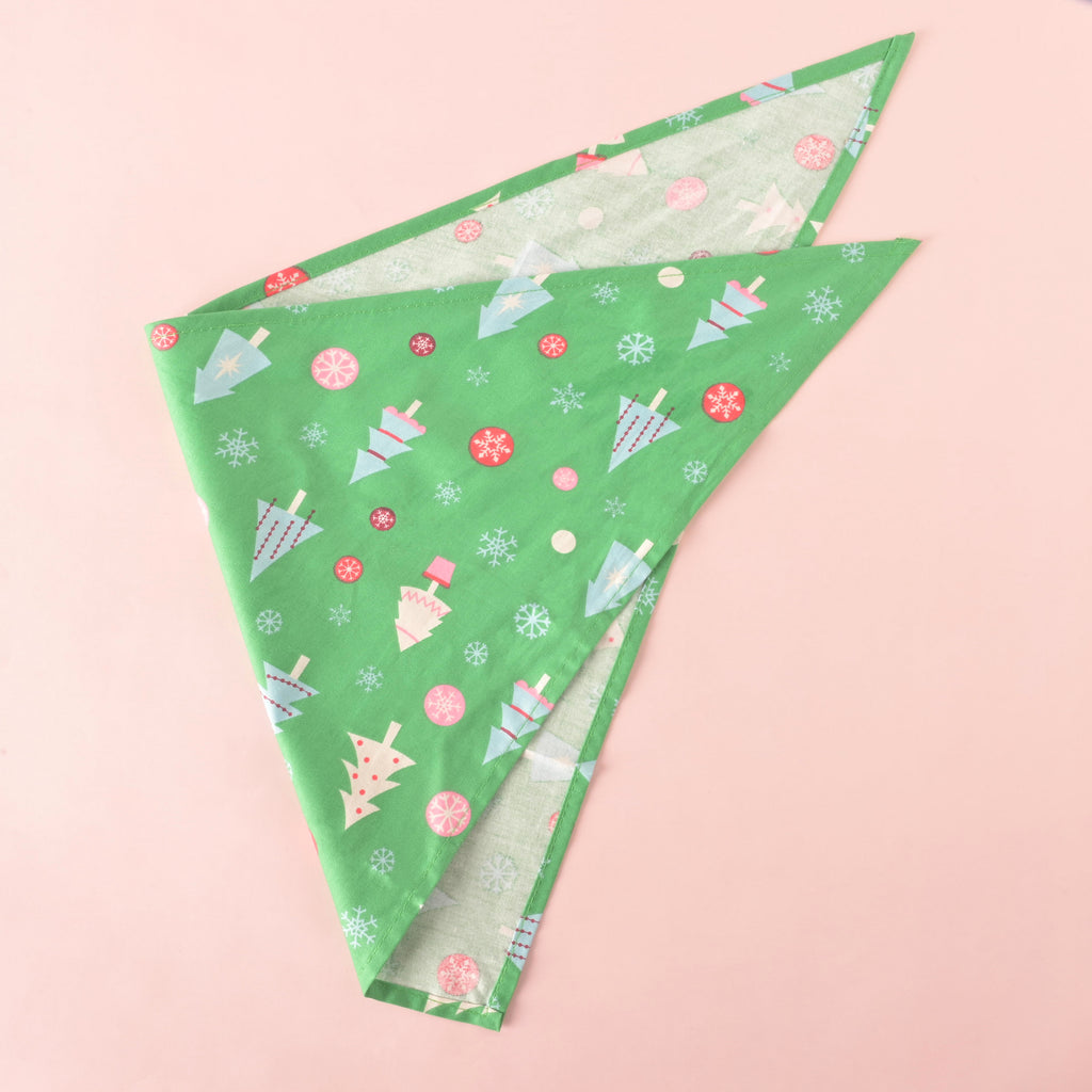 Festive green holiday pet bandana with Christmas trees, snowflakes, and ornaments, perfect for dogs and cats during the holidays.