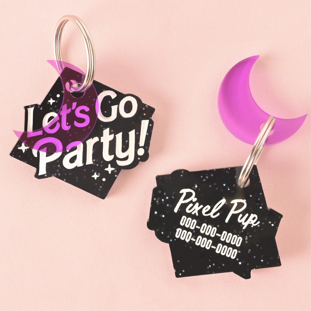 glitter black let's go party" barbie inspired pet tag with purple moon charm. image shows statement front and personalized back on solid pink background