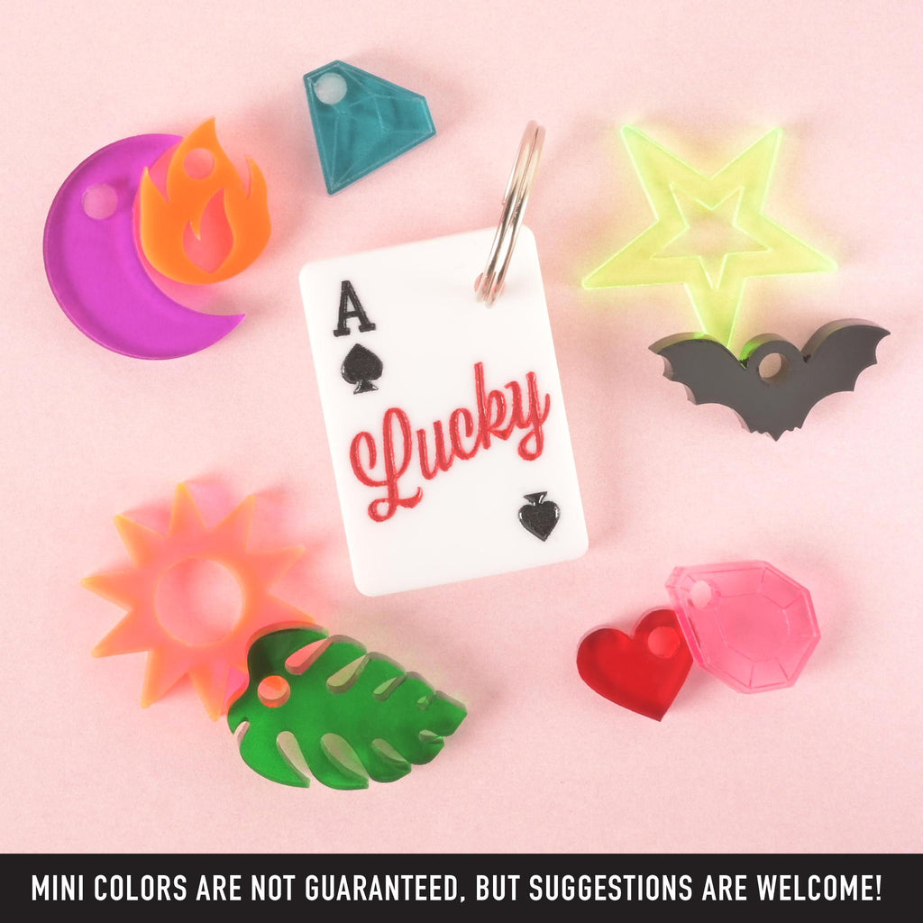 Lucky Ace playing card pet ID tag with red “Lucky” text, surrounded by colorful acrylic mini charms including moon, star, bat, and heart.