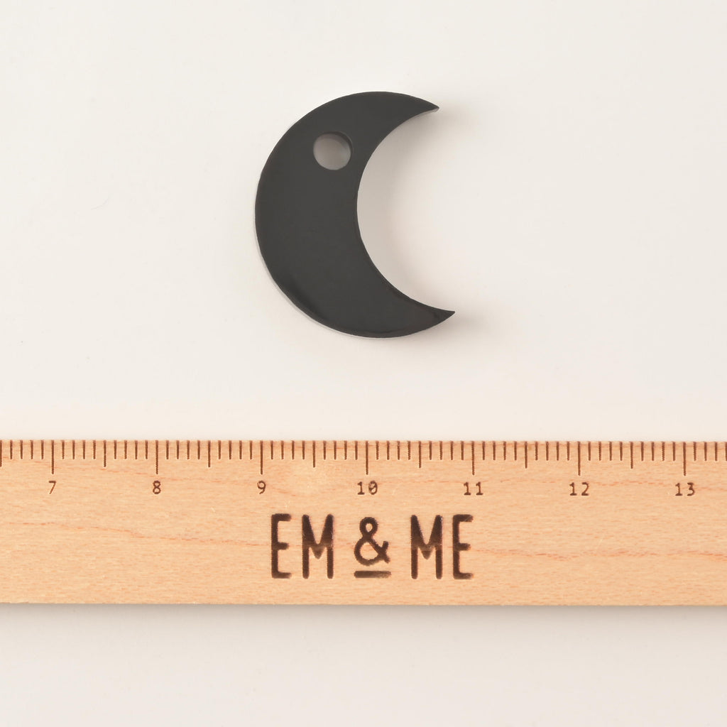 Black moon mini charm pet tag add on with wooden ruler that reads "EM & ME" on solid white background.