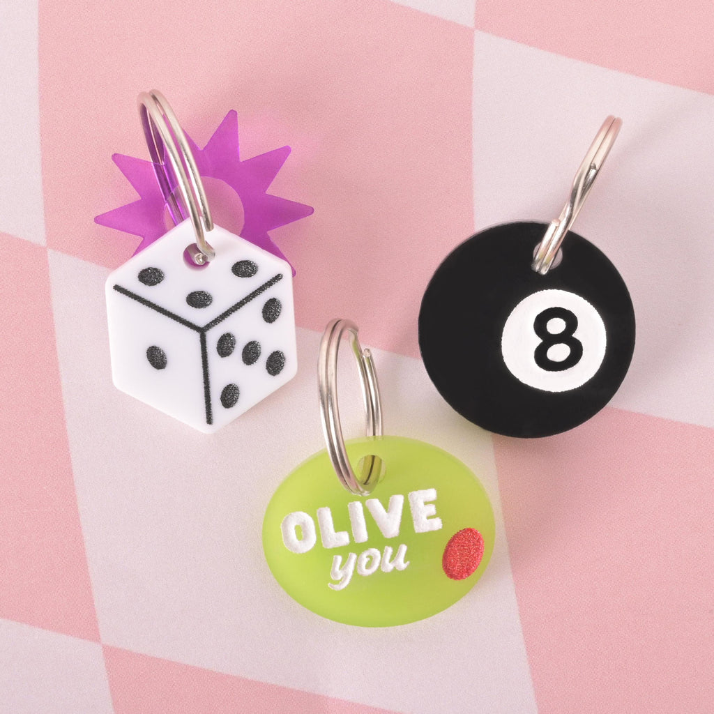 Set of novelty pet ID tags including Dice, 8 Ball, and Olive ‘Olive You’ designs, customizable name tags for cats and dogs.