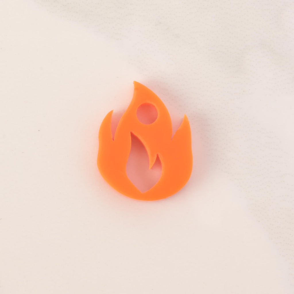 opaque orange flame-shaped mini charm on solid white background
