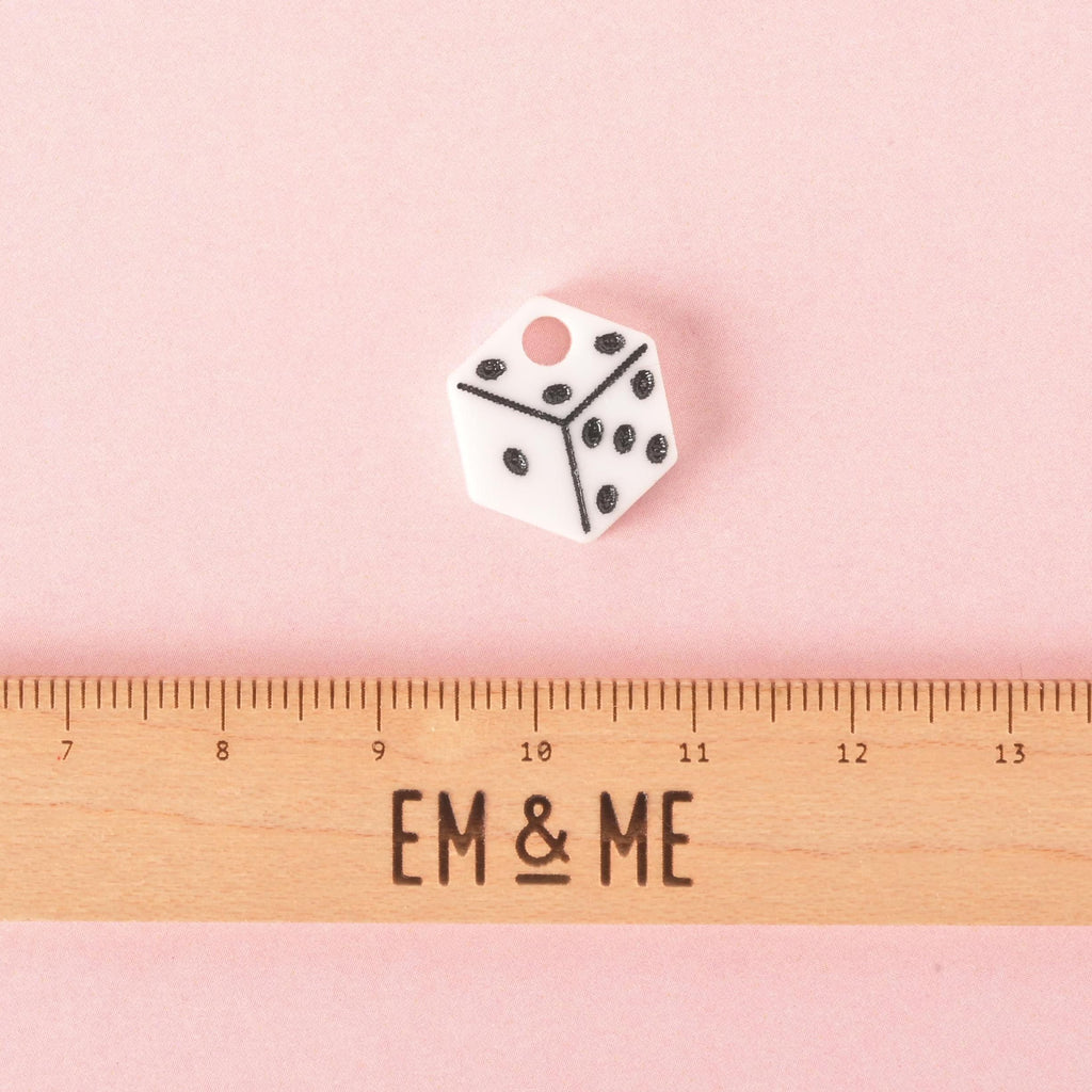 Small white acrylic dice pet charm with black dots shown above a ruler for scale, designed as a fun accessory for pet collars and tags.