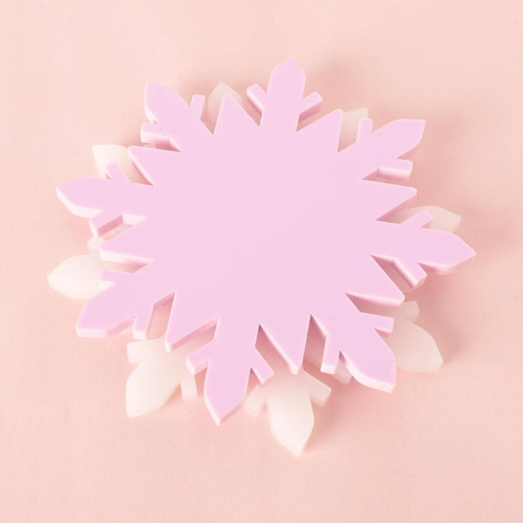 Set of pink and white acrylic snowflake coasters, festive Christmas table decor and holiday drink holders, perfect for winter entertaining.
