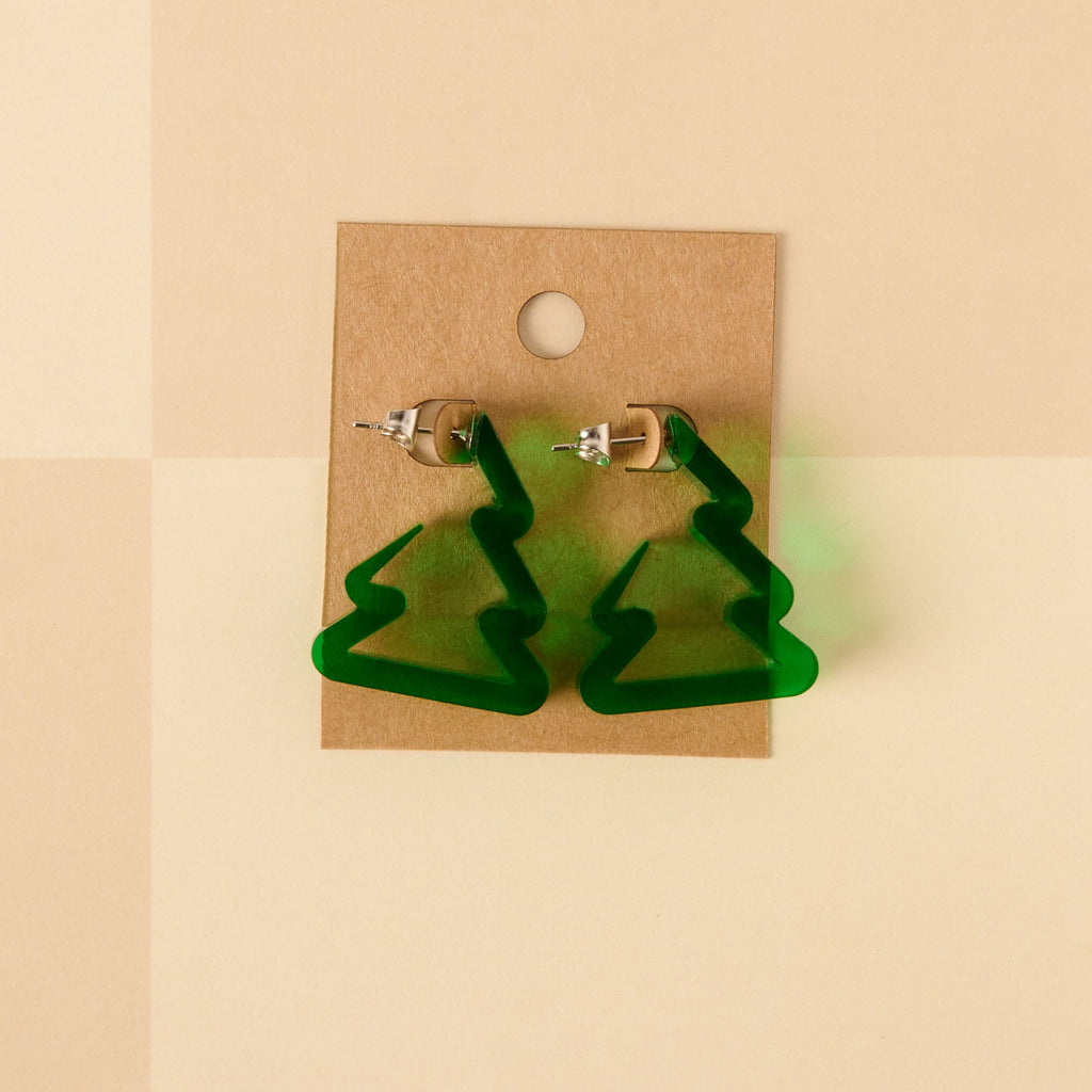 A pair of unique holiday earrings shaped like Christmas trees or zig-zag hoops in dark translucent green acrylic. The earrings are lightweight and displayed on a brown kraft jewelry card.