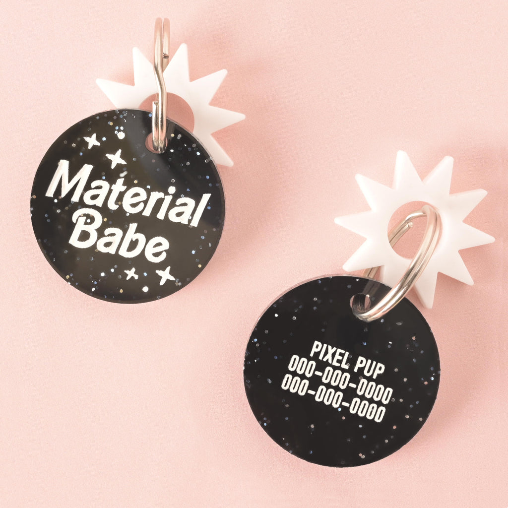 personalized pet tag that is glitter black acrylic and reads "material babe" on front and customized on the back with a name and two phonenumbers