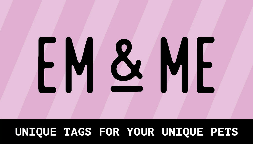 A collection of assorted personalized pet tags in various shapes and colors scattered on a white surface. The tags include a disco ball, a tennis ball, a Ouija planchette, a pretzel, a bone, a flower, and a heart. The items are shown with names like "Roger," "Shadow," and "Daisy." The image has a central black box with the text "EM & ME."