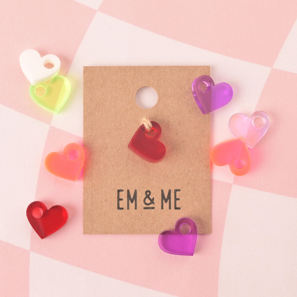 Collection of different colored tiny heart charm minis. Purple, pink, iridescent, while green, fluorescent pink and red