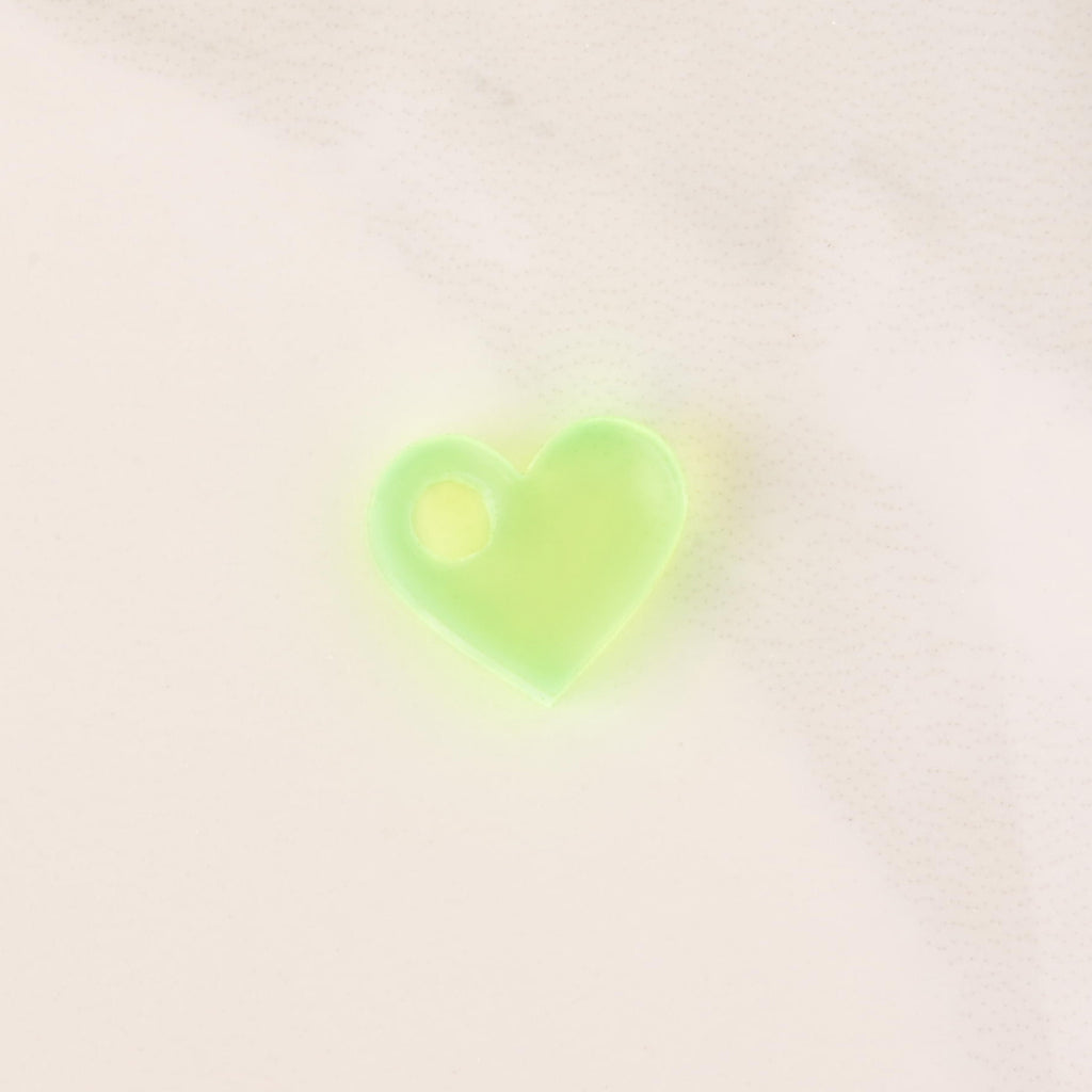 Fluorescent green tiny heart mini charm on solid white background