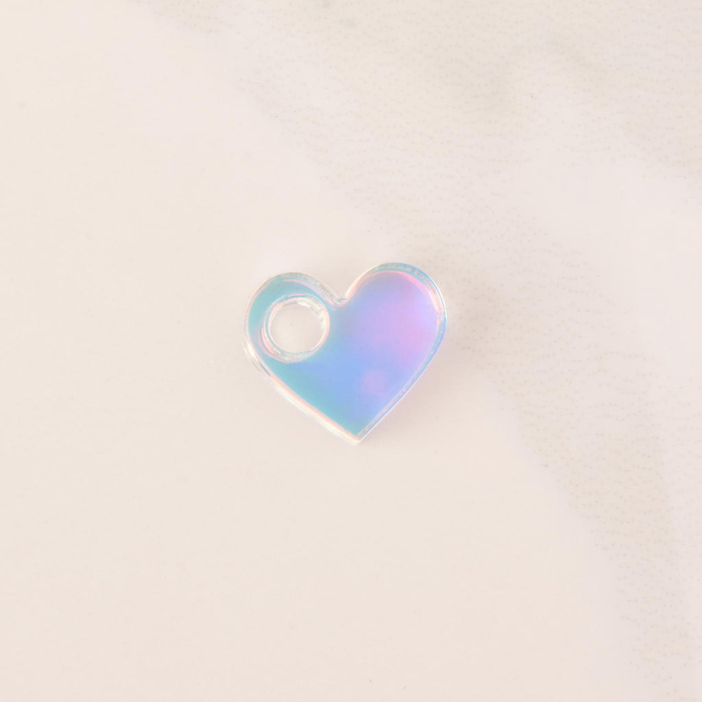 iridescent  tiny heart mini charm on solid white background