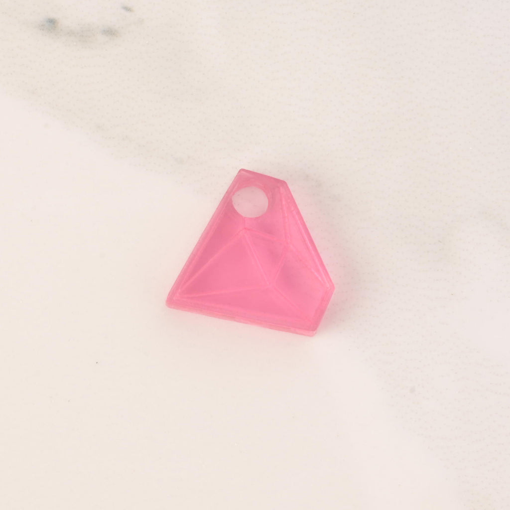 pale pink acrylic diamond-shaped mini charm with hole on solid white background