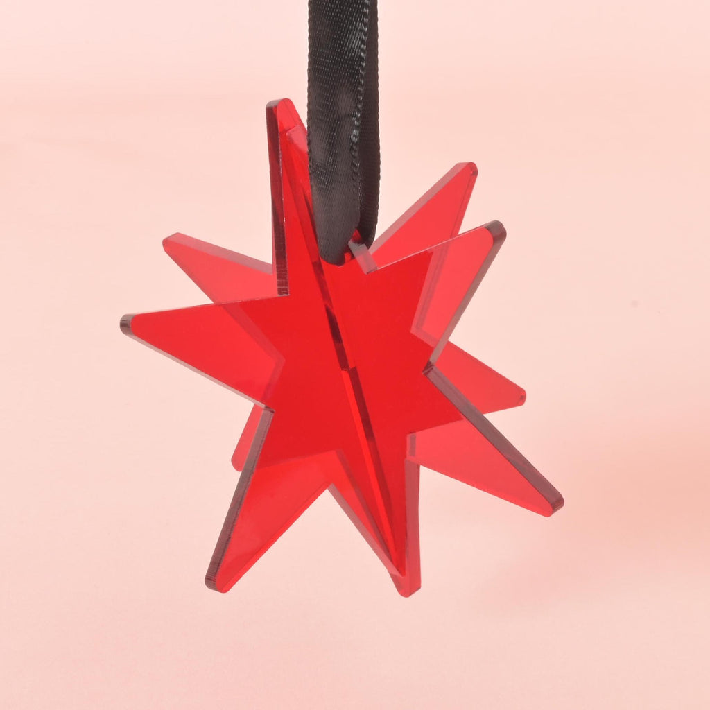 Red acrylic star ornament with black ribbon – modern holiday decoration for Christmas trees or gift wrapping