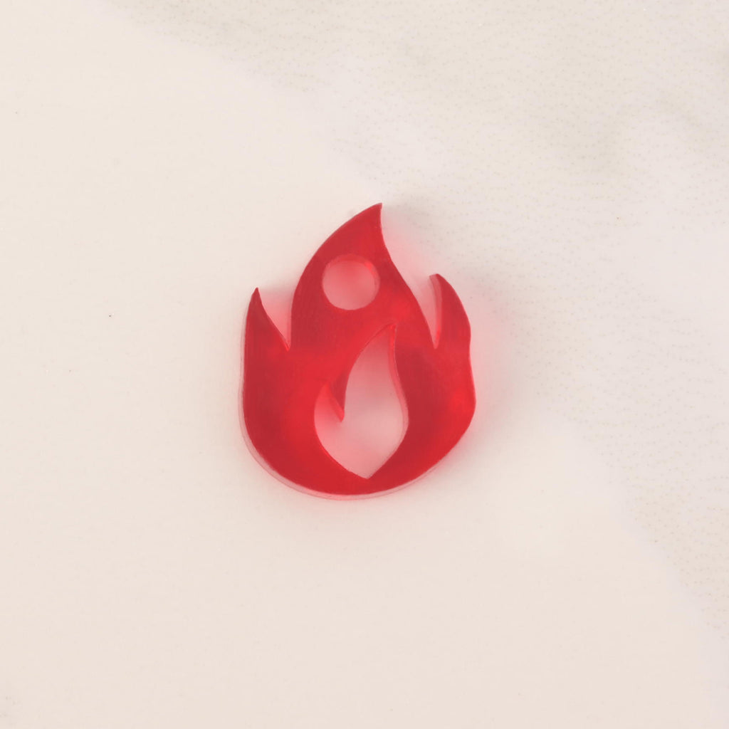 red flame-shaped mini charm on solid white background