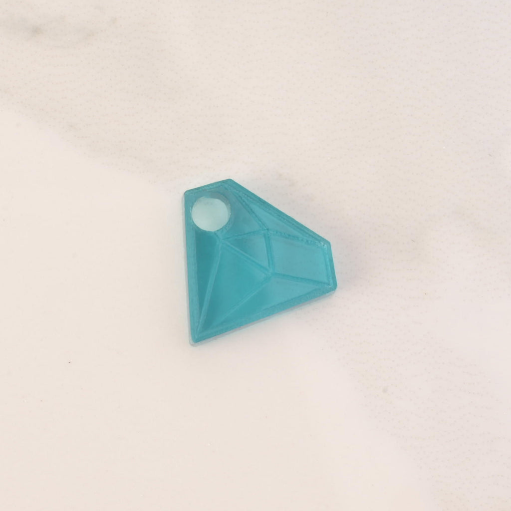 teal acrylic diamond-shaped mini charm with hole on solid white background