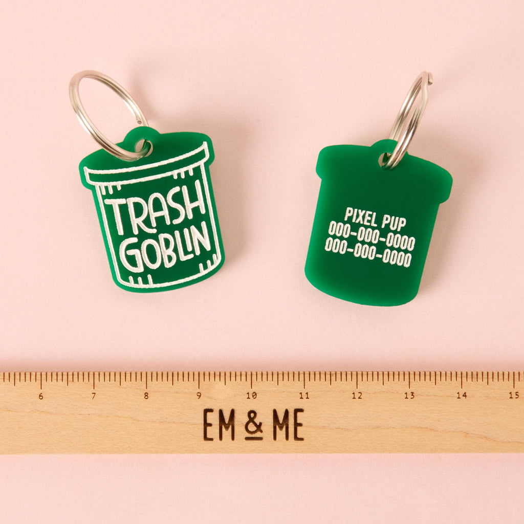 Engraved Trash Goblin tag showing custom name and phone number