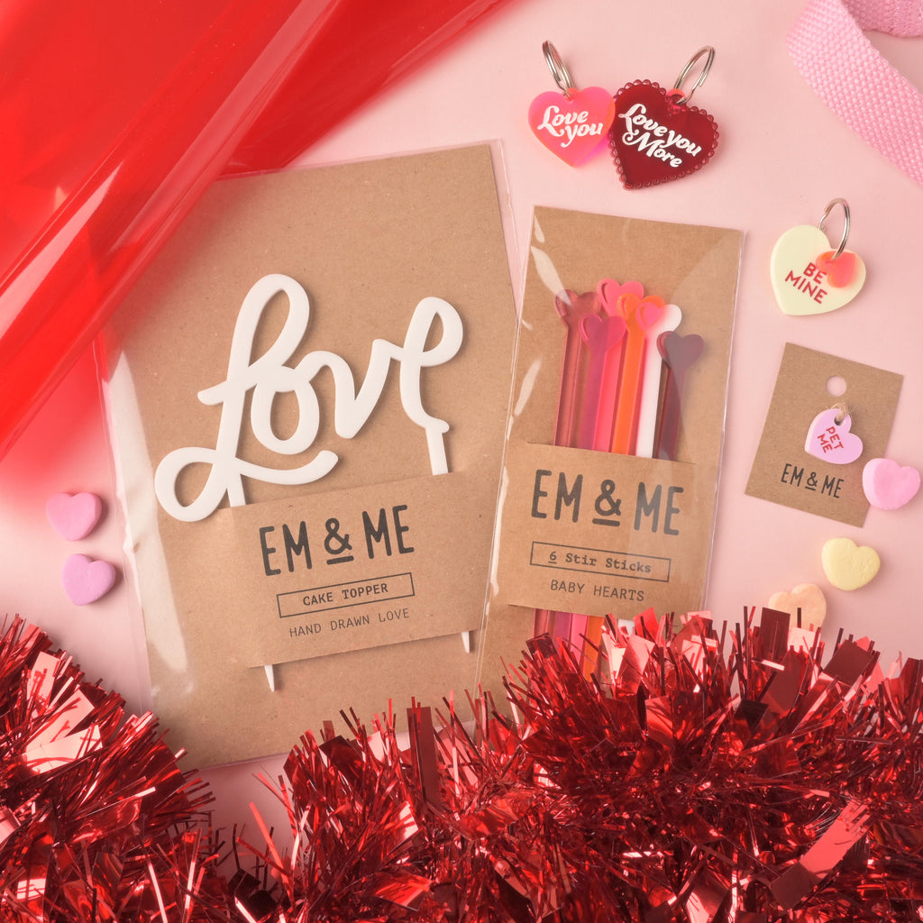 EM & ME Valentine's Day product flat lay. Includes 'love' cake topper, colorful heart stir sticks, heart-shaped pet tags, and red tinsel. Small Pet Me Heart, Candy Inspired, Valentine's Day, Seasonal Mini, Tiny Accessory for Pet ID Tag, Cats and Dogs Add-on Charm