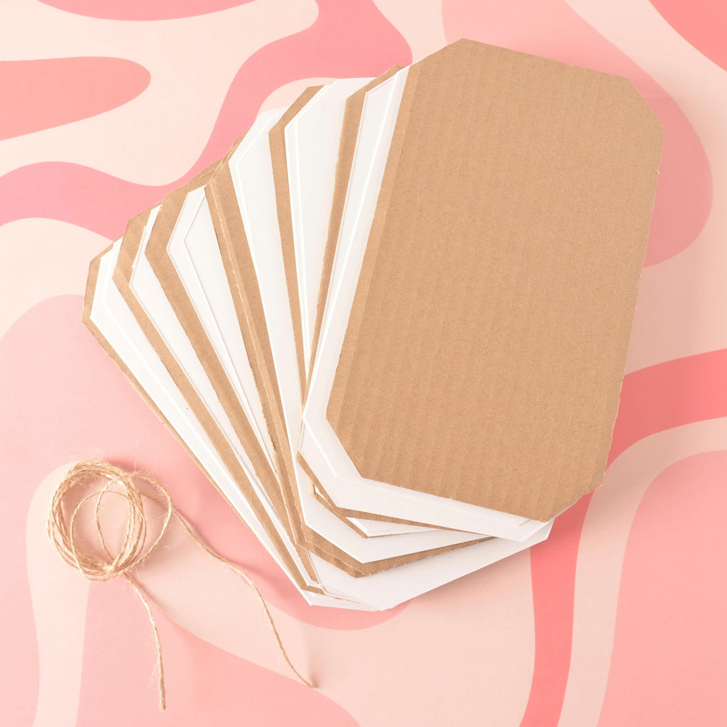 Flower Press Replacement Paper, 2 sets, Botanical Heirloom Flower Press A stack of brown corrugated cardboard sheets layered with white absorbent blotting paper, all cut with rounded corners, next to a coil of natural jute twine. The set is used as replacement material for a flower press.