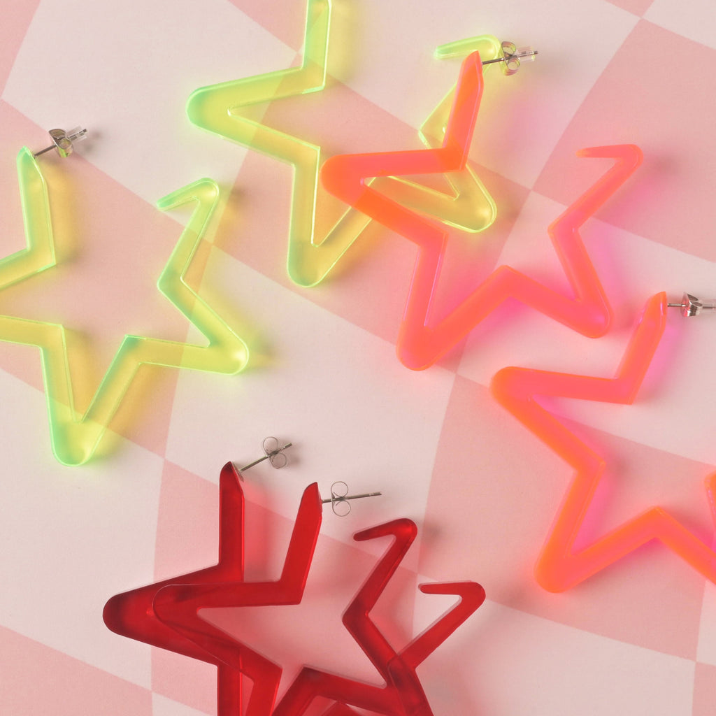 Large acrylic star hoop earrings set in neon yellow, orange, and red. Lightweight, colorful, and retro statement jewelry.
