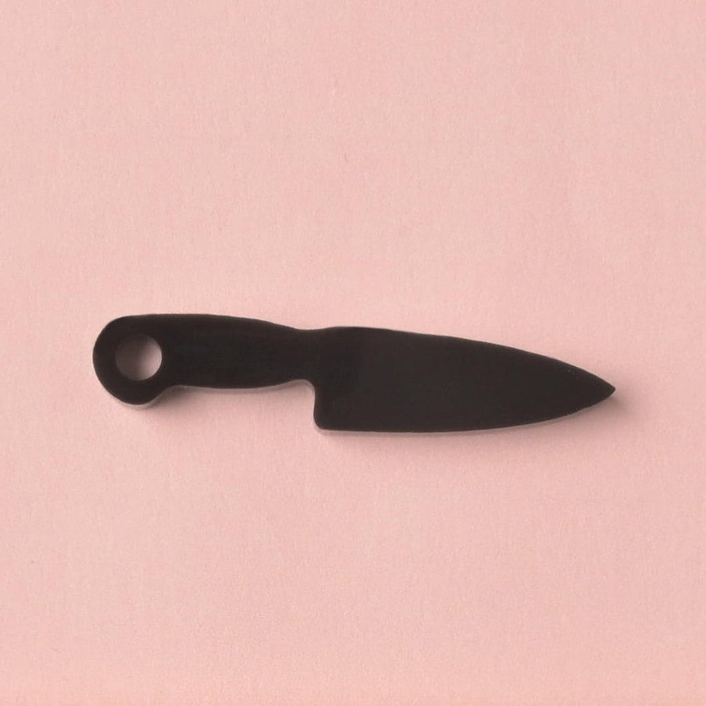 fake knife, Seasonal Mini,  Tiny Accessory for Pet ID Tag, Cats and Dogs Add-on Charm A small, opaque black acrylic mini charm shaped like a chef's knife with a circular hole for attachment. The charm is displayed on a solid pink background.