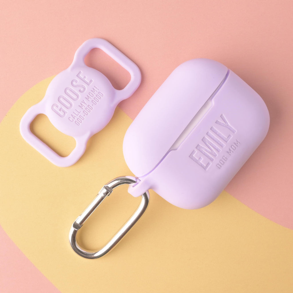 matching set of lavender silicone accessories: a personalized AirPods Pro case engraved with 'EMILY DOG MOM' and a silicone dog tag holder engraved with the name 'GOOSE' and contact information.