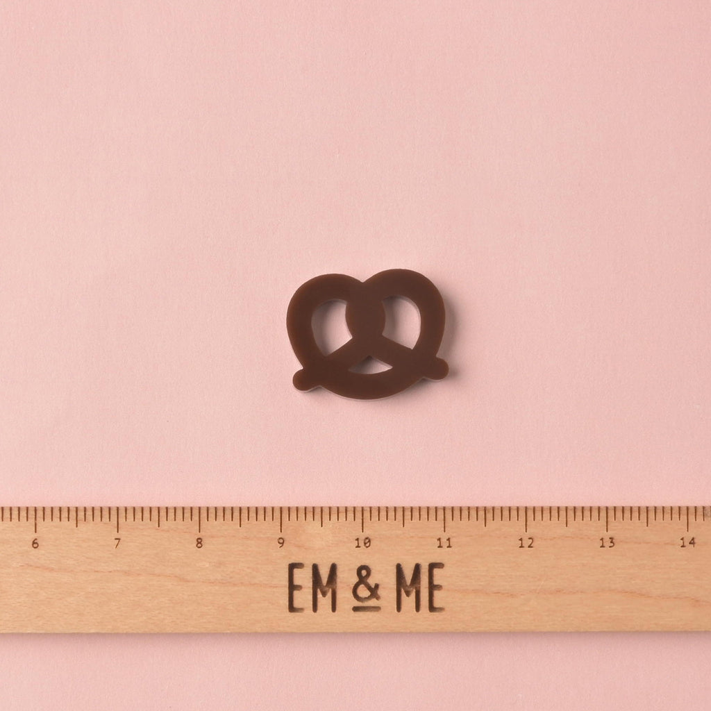 Pretzel, Seasonal Mini, Tiny Accessory for Pet ID Tag, Cats and Dogs Add-on Charm with ruler that reads "EM & ME" on solid pink background 