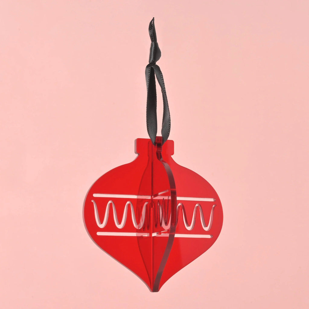 Translucent red acrylic 3D Christmas ornament. Interlocking layered geometric decoration with zigzag patterns. Hanging ornament with black ribbon. Playful Christmas ornaments, bright colors and non-breakable, kid Christmas