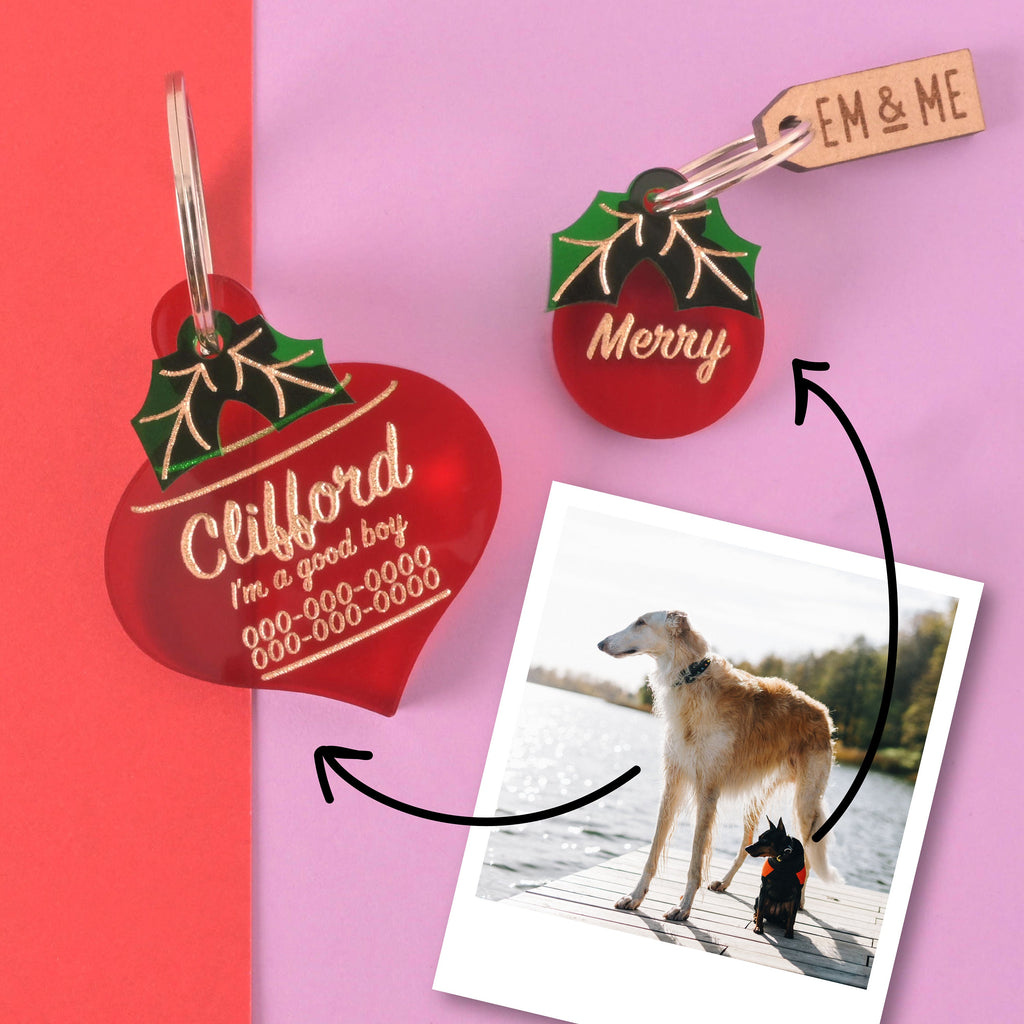 Personalized holiday dog tags for Clifford and Merry with holly detail, shown with a real pet photo and EM & ME branding – festive pet ID gift tags